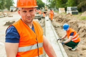 42783707 - construction worker in orange safety waistcoat and helmet